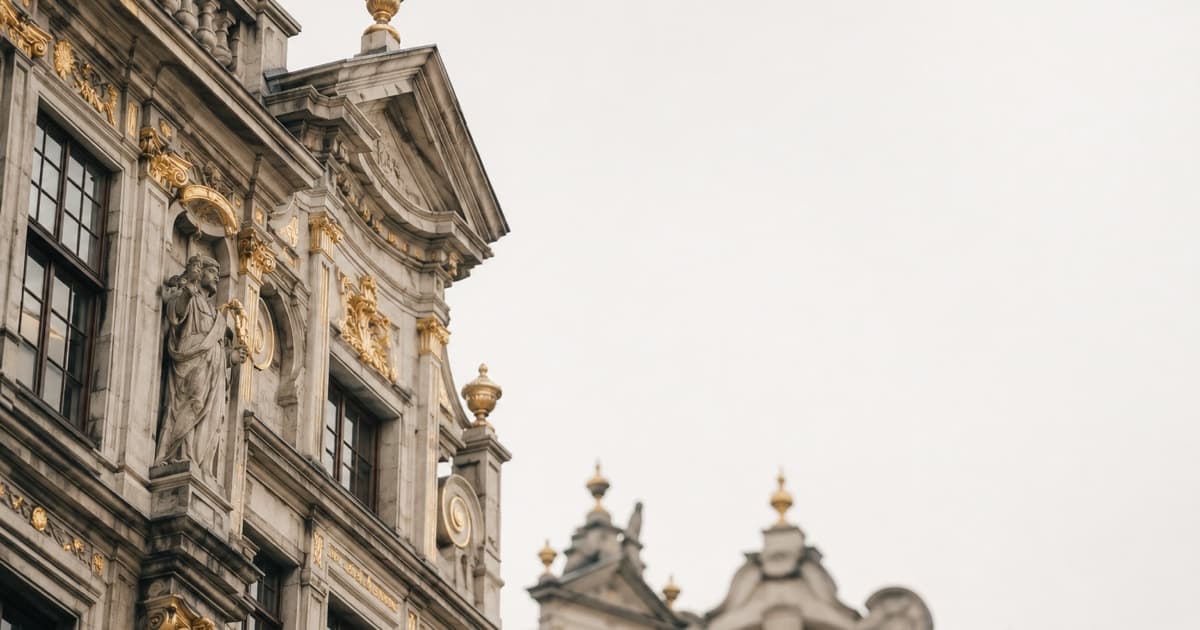 Close-up photo of ornate European civic building facades against a pale sky