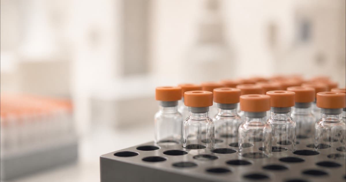 Laboratory vials arranged in a rack, macro shot