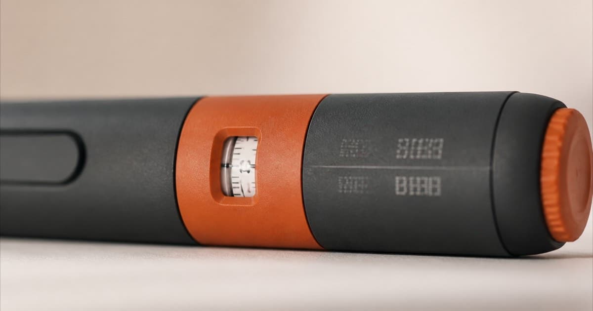 Close-up of a lot number and expiration date printed on an injection pen
