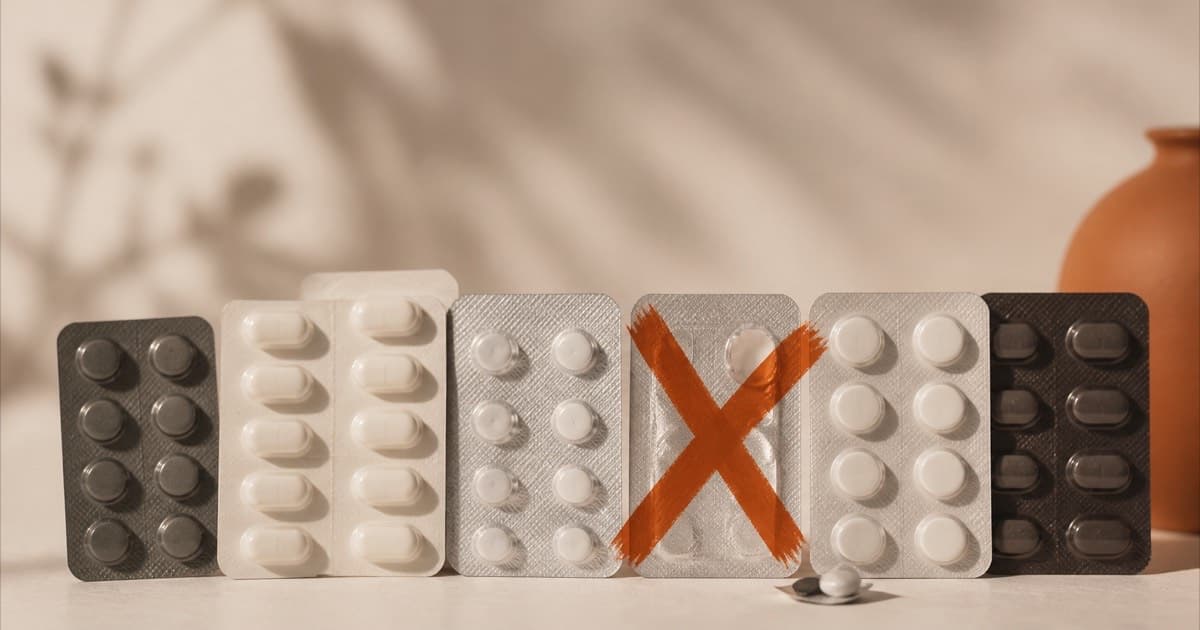 A stack of capsule blister packs with one package set aside